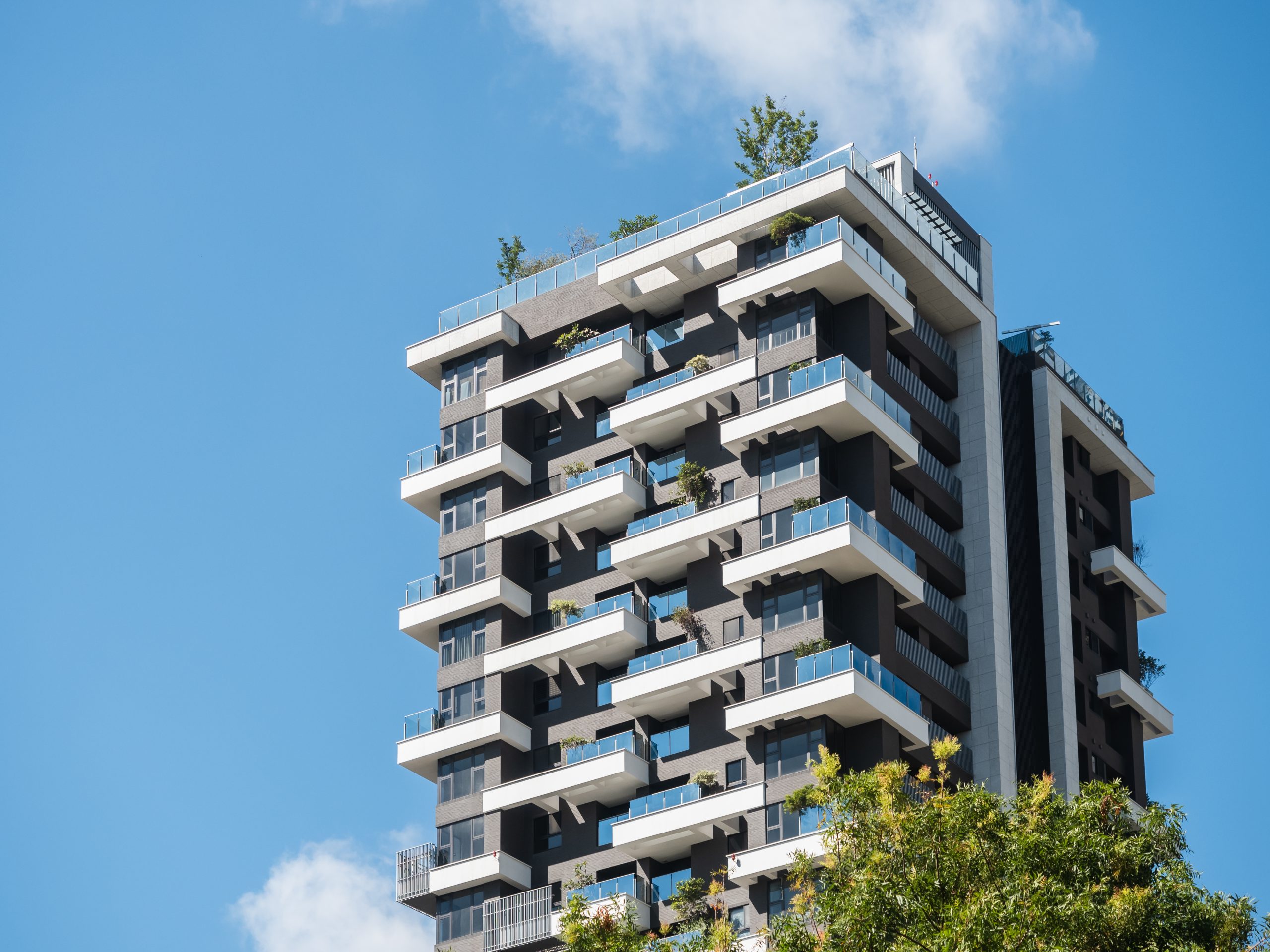 A high residential block against a blue sky