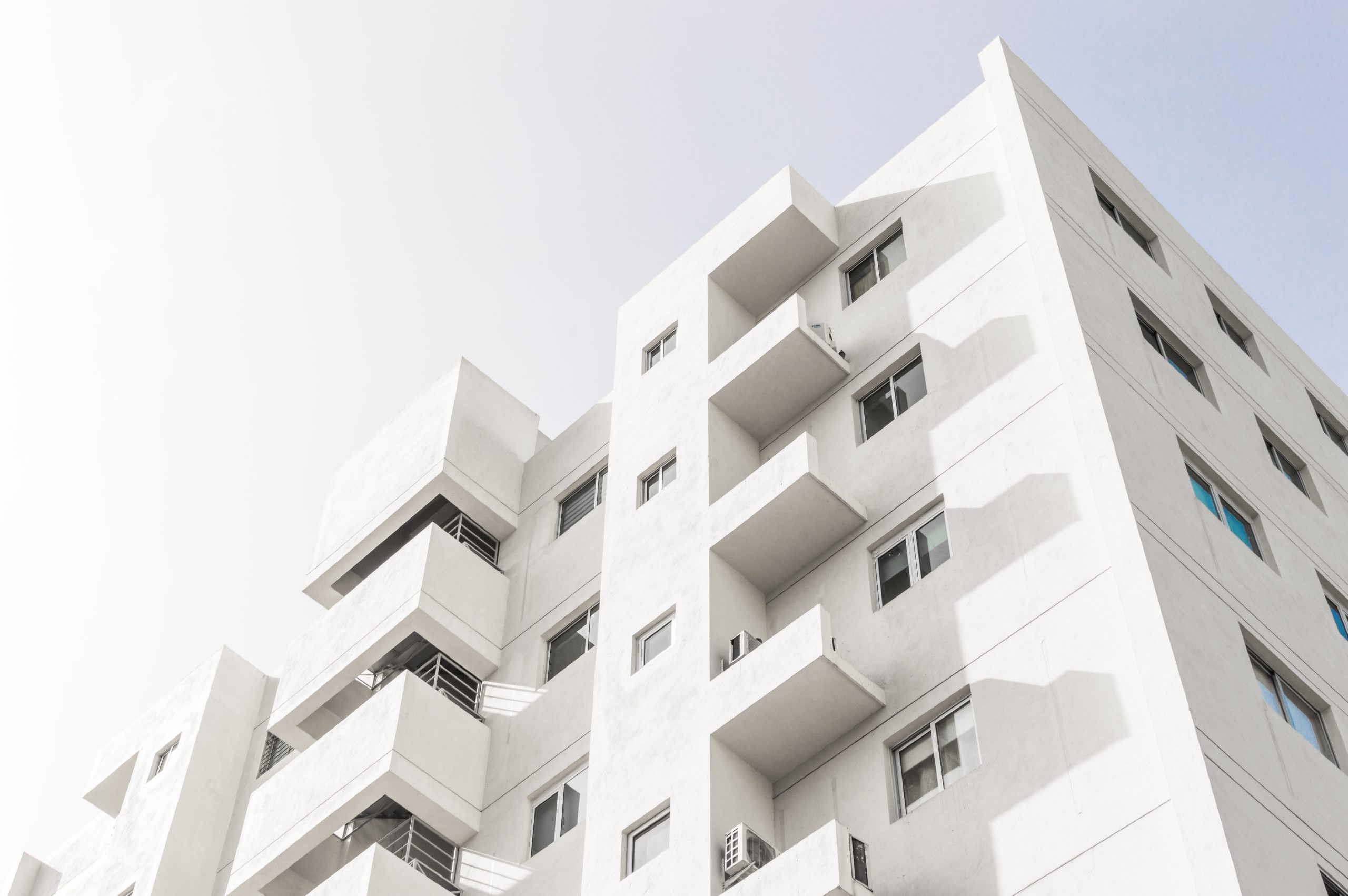 Low angle view of a white modern apartment building